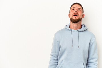 Young caucasian man with diastema isolated on white background shouting very angry, rage concept, frustrated.