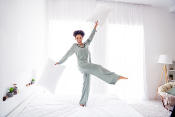 Full length body size view of attractive cheerful girl dancing on bed having fun at light white home indoors