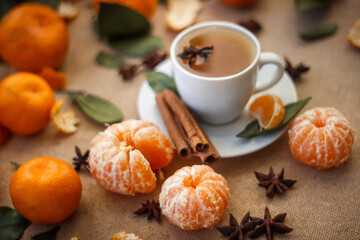 Obraz na płótnie Canvas Christmas tangerines with a cup of cocoa, cinnamon and star anise