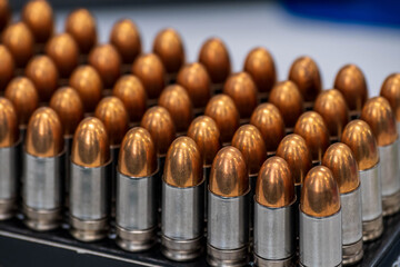 A handful of short-barreled bullets were placed on the table, beside the numerous boxes of ball bearings.