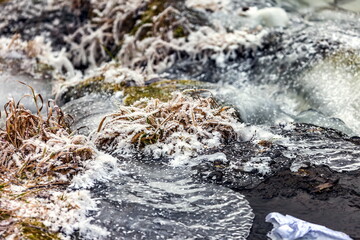 Fast river with ice and snow in late autumn