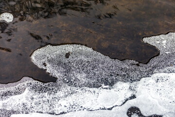 Fast river with ice and snow in late autumn