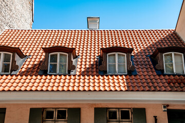 Low rise house with sloping red tiled roof and dormer windows (1117)