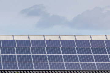 Green energy concept, A solar cell panel on the rooftop under blue sky, Photovoltaic cell is an electrical device that converts the energy of light directly into electricity by the photovoltaic effect