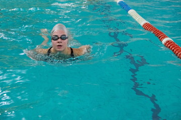 A girl swimming in a swimming pool.