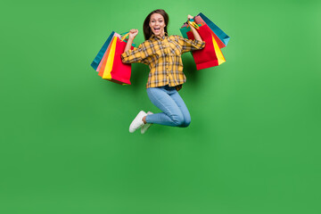 Full body portrait of carefree overjoyed girl hold packages celebrate success isolated on green...
