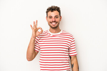 Fototapeta premium Young caucasian man isolated on white background cheerful and confident showing ok gesture.
