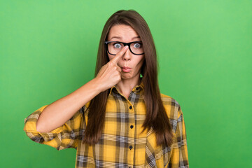 Photo of stunned young girl finger touch fixing glasses look camera facial reaction isolated on green color background