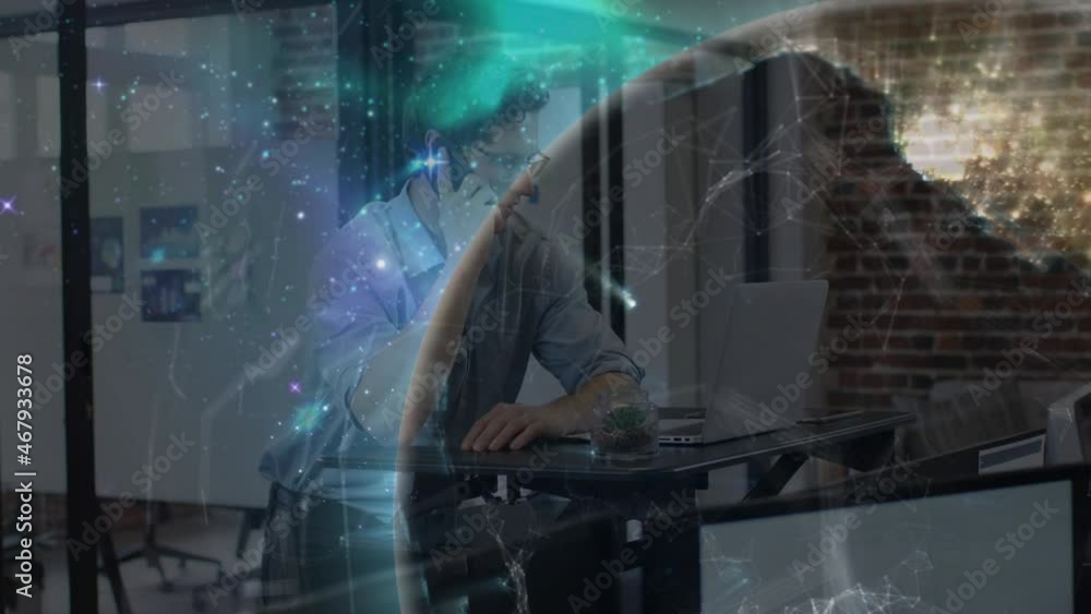 Poster animation of glowing global communication network over man using smartphone and laptop in office