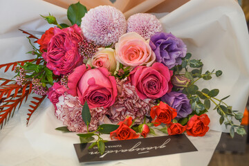 A bouquet of colorful pink flowers cluster on display in a flower shop
