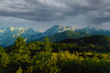 Fototapeta na wymiar Dramatic dark sky against the backdrop of mountains.
