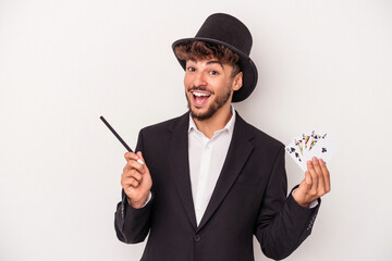 Young arab wizard man holding a magic cards and wand isolated on white background