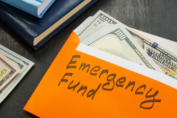 Emergency fund sign on the envelope with money.