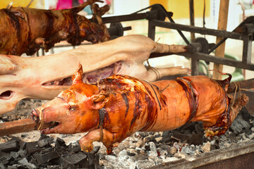Traditional Balkan barbeque - roshtilj (roštilj) - young piglet and lamb roasted on the open fire 