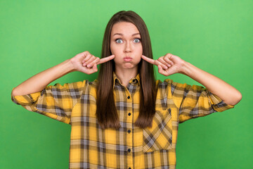 Portrait of satisfied person hands fingers press big cheeks hold breath isolated on green color background