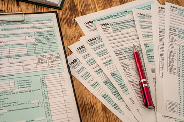 US tax forms 1040 ready to fill US citizens with a pen lying on the table