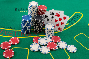 colored brand new chips columns stand with fan cards on a poker table