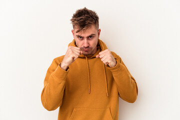 Young caucasian man isolated on white background showing fist to camera, aggressive facial...