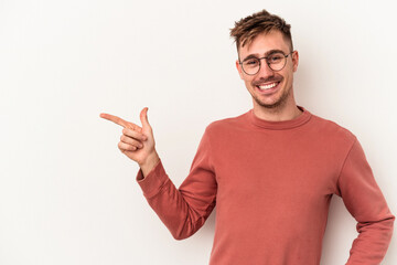 Young caucasian man isolated on white background smiling cheerfully pointing with forefinger away.