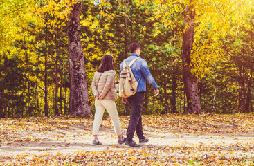 Fototapeta premium A guy and a girl walk along the path in the city Park 