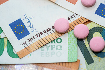 different pills on euro bills as background
