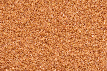 Brown sugar background. Cane sugar crystals texture.