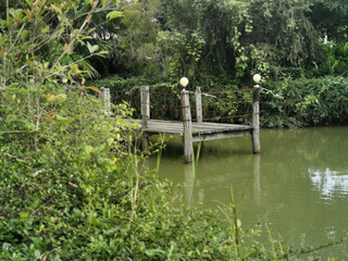 Fototapeta na wymiar old wooden pier footbridge by lake