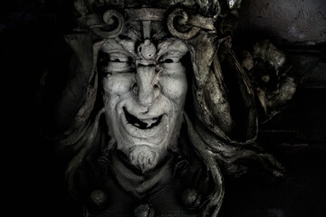 Close up monster face of aGreek antique god daimon of eager rivalry, envy, jealousy, and zeal Zelus...