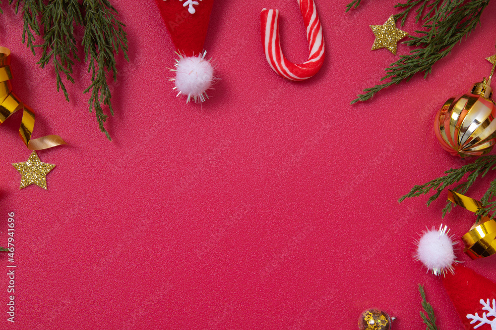 Wall mural christmas red background with decorative elements and green branches flat lay copy space