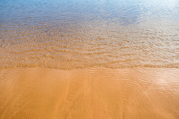 Fototapeta na wymiar sand beach and the sea on a sunny day with gradient on tenerife