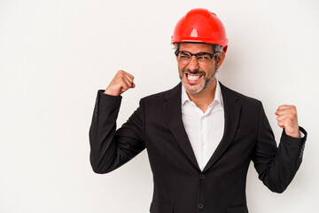 Middle age architect caucasian man isolated on white background  raising fist after a victory, winner concept.
