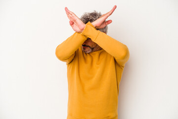 Middle age caucasian man isolated on white background  keeping two arms crossed, denial concept.
