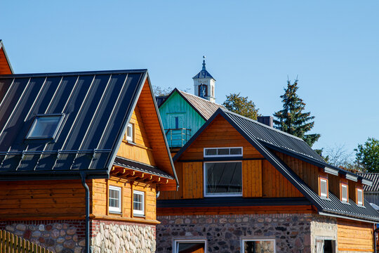 Wooden houses. Classic metal roof. Colorful Houses