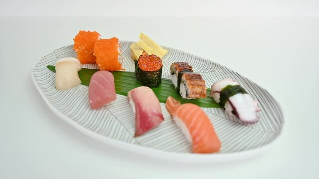 Variety of japanese nigiri sushi set of traditional food on white plate