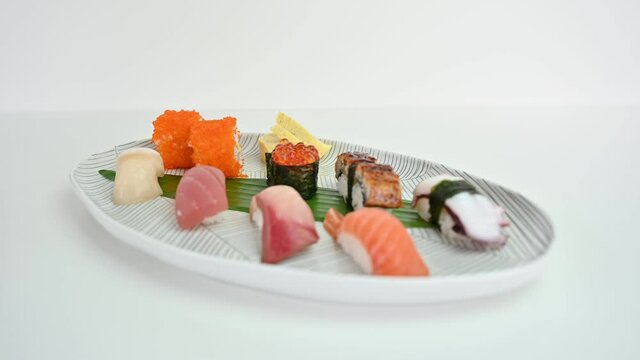 Variety of japanese nigiri sushi set of traditional food on white plate