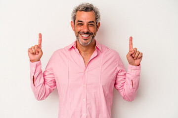Middle age caucasian man isolated on white background  indicates with both fore fingers up showing...