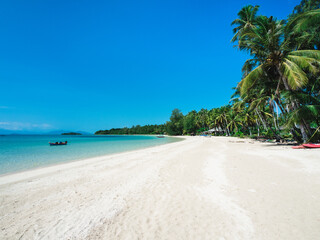 Fototapeta na wymiar Peaceful white sand beach tropical island with turquoise water, coconut palm tree and local fishing boat. Koh Mak Island, Trat Province, Thailand.