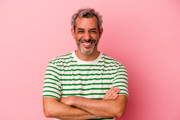 Middle age caucasian man isolated on pink background  who feels confident, crossing arms with determination.