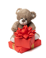 cute brown teddy bear and box wrapped in paper and red silk ribbon on white background. Prize and congratulations