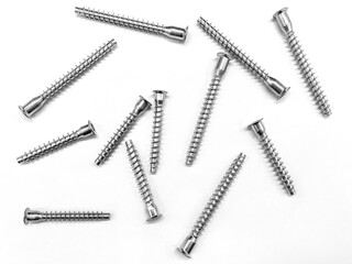 Background of screws and dowels. Objects on a white background. Bolts for repair.