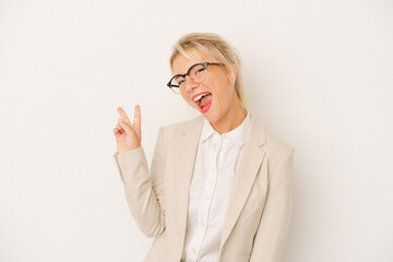 Young business Russian woman isolated on white background joyful and carefree showing a peace symbol with fingers.