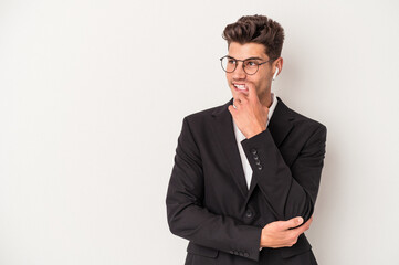 Young business caucasian man wearing headphones isolated on white background relaxed thinking about something looking at a copy space.