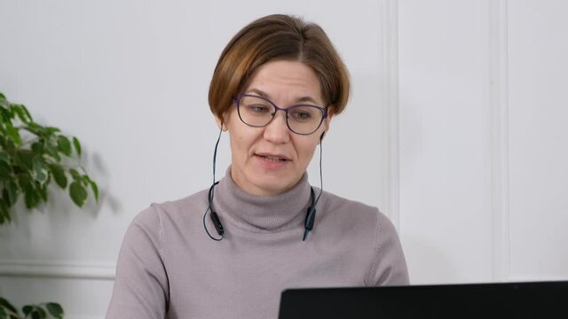 Female office worker talking to client using virtual chat computer app. Woman video calling distant colleage or student on laptop.
