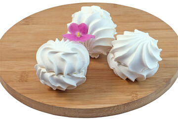 Delicious sweet airy light marshmallow with vanilla flavor on a wooden board, isolated on a white background.