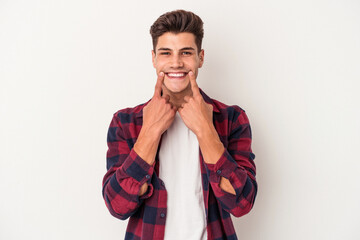 Young caucasian man isolated on white background doubting between two options.