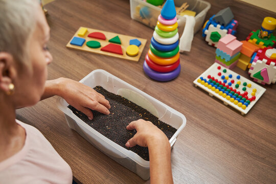 Mature patient performing recovery activities in rehab center