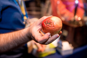 Hand holding and apple that was carved into with electricity