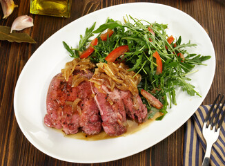 Fine Meat - Boiled Cured Veal Tongue Meat Slices with roasted Onions and Salad  on wooden Background