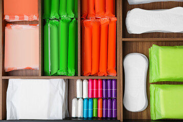 Storage of different feminine hygiene products in wooden organizers, top view - obrazy, fototapety, plakaty