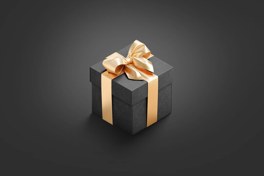 Blank black gift box with gold ribbon mockup, dark background